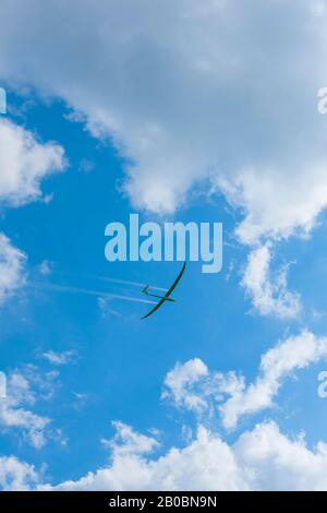 Glider about to land in a cloudy sky, Germany Stock Photo
