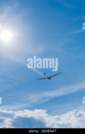 Glider about to land in a cloudy sky, Germany Stock Photo