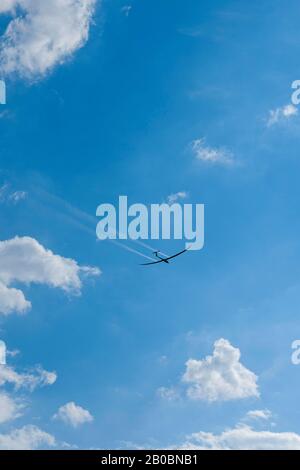 Glider about to land in a cloudy sky, Germany Stock Photo