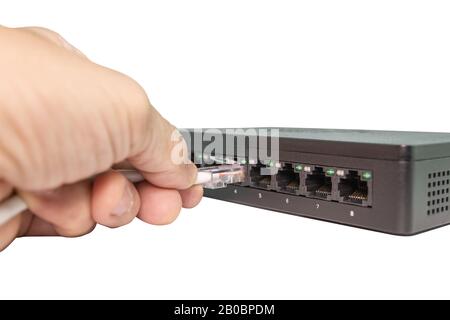Hand of man holding The blue network cables connect port switch on white table concept internet network connection, clipping path Stock Photo
