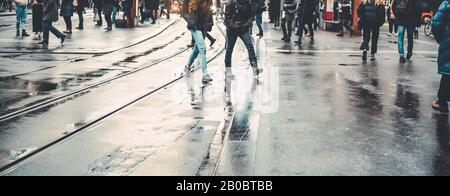 Urban city view of people crowd walking outside of bus station - Concept of modern, rushing, urban, city life, business, shopping - Focus on center pe Stock Photo