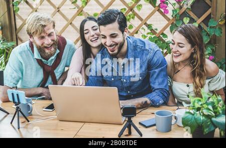 Young people streaming online using laptop, smartphone and action cameras - Millennial friends having fun with new technology trends - Social network, Stock Photo