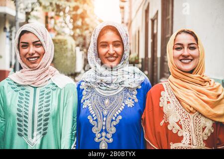 Portrait of arabian girls outdoor in city street - Young islamic women smiling on camera - Youth, friendship, religion and culture concept - Focus on Stock Photo