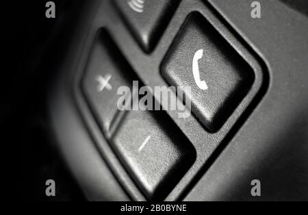 mobile phone buttons on car steering wheel Stock Photo