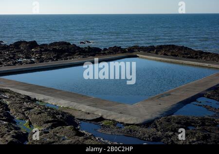 Square Outdoor Rock Swimming Pool above the Beach at Westward Ho! on the South West Coastal Path, North Devon, England, UK. Stock Photo