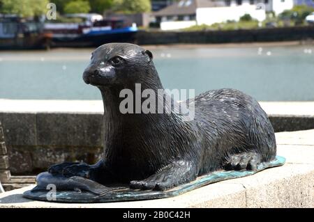 Bronze Statue of Tarka the Otter Lying down in Bideford (Kingsley's Little White Town) on the Tarka Trail/South West Coast Path, North Devon. England. Stock Photo