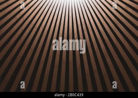 Abstract brown wooden background with gradient. Thin wooden vertical inclined planks. Inside the chandelier. Blurred photo. Stock Photo