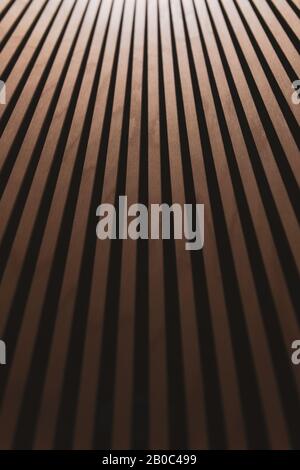 Abstract brown wooden background with gradient. Thin wooden vertical inclined planks. Inside the chandelier. Blurred vertical photo. Stock Photo