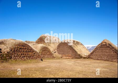 Traditional turf houses of Glaumbauer ethnographic Farm Museum, Skagafjordur, Iceland. View to rear of the buildings against clear blue sky background Stock Photo