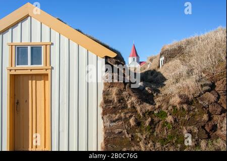 Traditional turf houses of Glaumbauer ethnographic Farm Museum, Skagafjordur, Iceland.  Yellow and white timber houses against clear blue sky backgrou Stock Photo