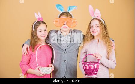 Group kids bunny ears accessory celebrate Easter. Children with little basket ready hunting for Easter eggs. Easter activity and fun. Friends having fun together on Easter day. Ready for eggs hunt. Stock Photo