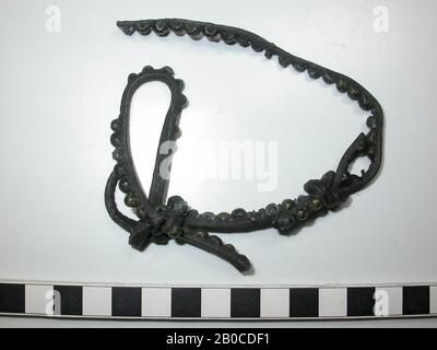 Fragment leather belt with fittings. Multiple sections of belt that are tied together with 2 knots. The whole consists of 3 fragments. On the fragments are about 64 decorative nails of lead (diameter: 0.5 cm, thickness: 0.2 - 0.4 cm) with a cap of copper alloy. Some studs with caps are missing completely and there are 4 decorative nails without cap visible. The color of the batter is dark gray to black because of the corrosion of the lead. There is no space between the caps and the fittings are as wide as the leather. Thickness of the belt with batter: 0.6 cm. Nail diameter: 0.05 - 0.15 cm Stock Photo