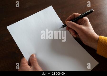 the decision to write in front of a white sheet Stock Photo