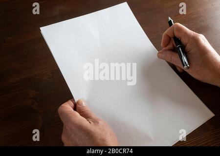 the decision to write in front of a white sheet Stock Photo