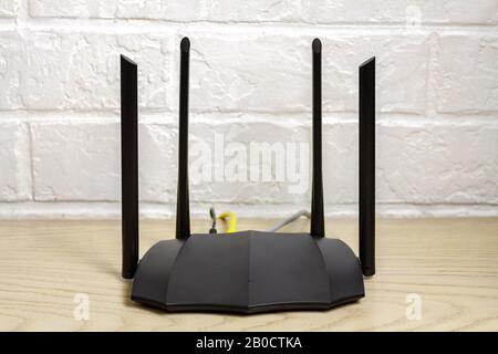 Home dual band gigabit wifi router transmitting high speed internet.Selective focus with shallow depth of field. Stock Photo