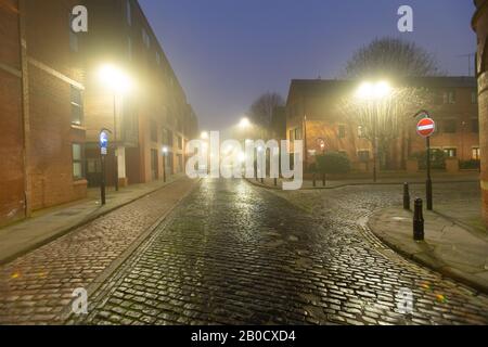 Street at the center of Leeds near the canal at a foggy dawn Stock Photo