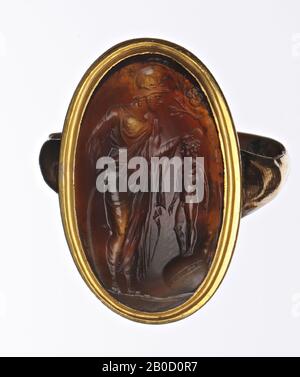 Vz: Minerva standing at shield to the right, she holds hand over head of little boy on globe at tree, ground line, gem, intaglio, agate, Color: brown with spots, Shape: oval, standing, Processing: in golden ring, Method of manufacture: 26 x 14.5 mm, D. 4.5 mm, wt. 5.9 gr., 18th century 1700-1800 Stock Photo