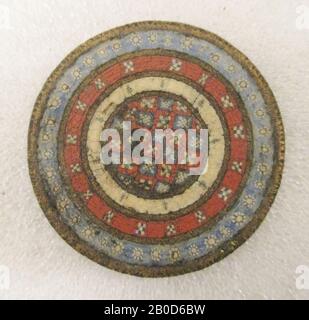 Roman round disc fibula. The fibula is decorated at the front with 8 concentric circles of enamel and brass. The email has a red, blue or beige color. In the enamel flower patterns and checkerboard patterns can be observed. On the back of the fibula is the confirmation of the needle still visible., Disc fibula, metal, bronze, enamel, Diameter: 4.5 cm., Roman 1-275 AD, Netherlands, Utrecht, Bunnik, Fighting Stock Photo