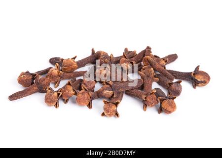 Pile Clove (Syzygium aromaticum) isolated on white background. Used as a spice in cuisines all over the world. The plant is also used in medicine. Stock Photo