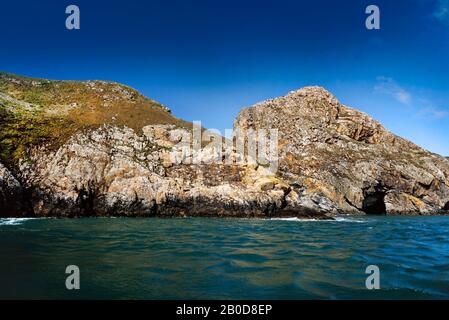 Ramsey Island, UK, coastal scenery, sheer cliffs showing sea & wind erosion, summer, viewed from the sea. Stock Photo