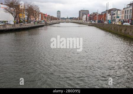 Dublin, Ireland - Feb 20th, 2020: View of the Liffey River and the Halfpenny Bridge, Dublin, Ireland Stock Photo