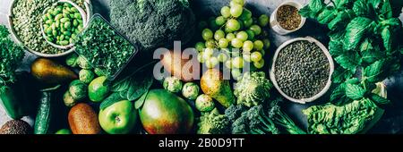 Variety of Green Vegetables and Fruits on the grey background, banner size Stock Photo