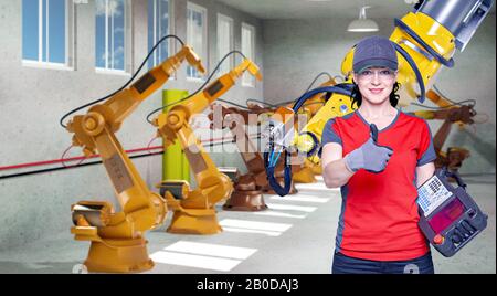 A young female technician while machine constructing in a manufacturing plant Stock Photo
