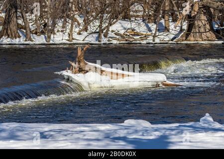 Small weir on river in winter Stock Photo