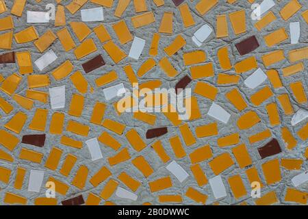 Abstract mosaic on the wall. Yellow, white, cinnamon rectangles in a chaotic manner Stock Photo