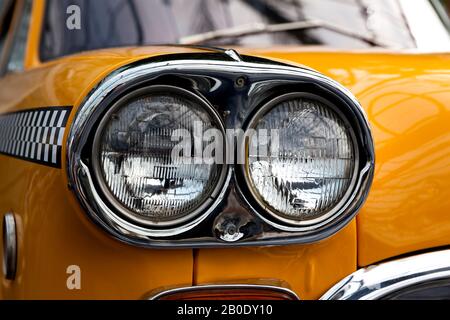Headlight of an old yellow retro car, close-up Stock Photo