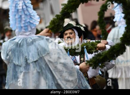Mittenwald, Germany. 20th Feb, 2020. The Mittenwald bell stirrers move through the village during the traditional carnival. With the bells they ring in the spring in Upper Bavaria. Credit: Angelika Warmuth/dpa/Alamy Live News Stock Photo