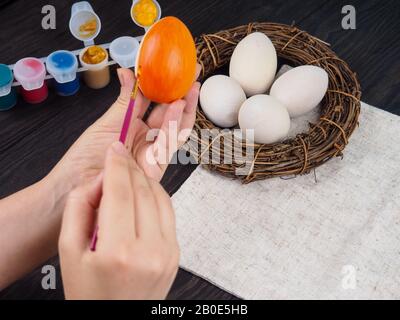 easter, family, holiday and concept - close up coloring eggs for easter. Stock Photo