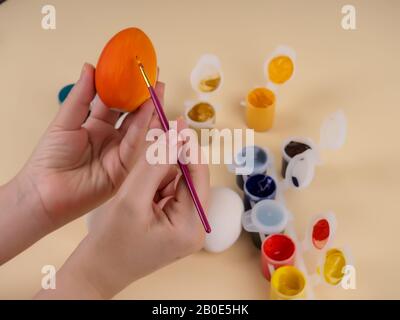 easter, family, holiday and concept - close up coloring eggs for easter. Stock Photo