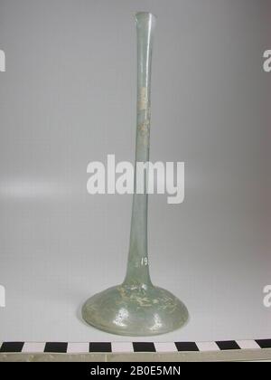 Bottle of decolored glass with a flat, broad bottom and a very long, narrow neck. The mouth rim is damaged., Crockery, glass, H 18 cm, Israel Stock Photo