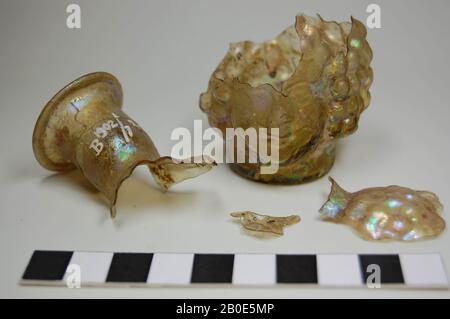 Bottle of green, strongly iridescent glass with a flat bottom, narrow neck and opening. The body is formed by two faces placed against each other. Broken, crockery, glass, H 8.5 cm, Lebanon Stock Photo