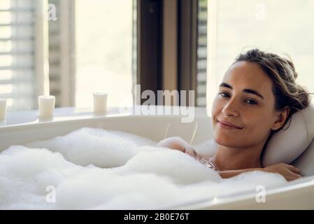Young woman relaxing in bathtub Stock Photo