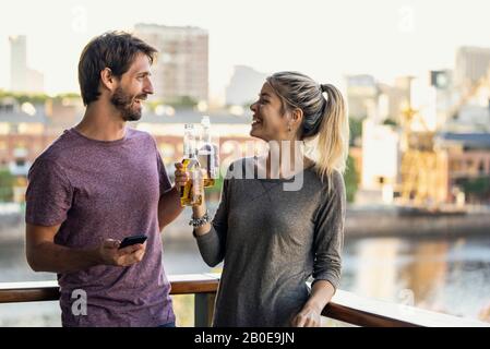 Young couple standing on balcony Stock Photo