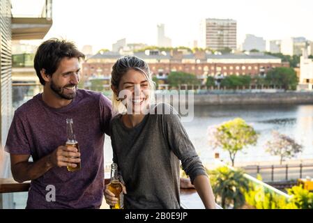Young couple standing on balcony Stock Photo