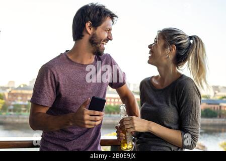 Young couple standing on balcony Stock Photo