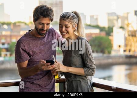 Young couple using smartphone Stock Photo