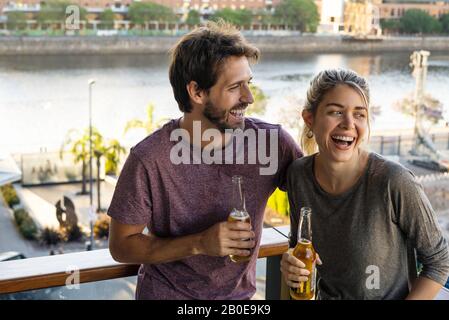 Young couple standing on balcony Stock Photo