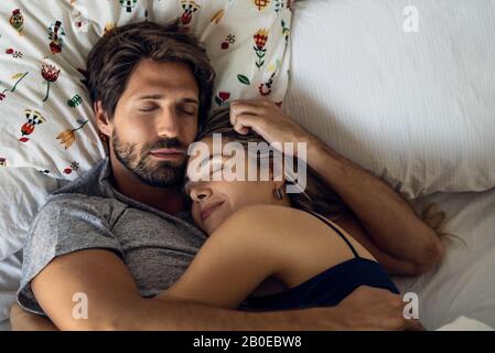 Couple sleeping on bed Stock Photo