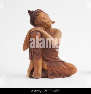 A wooden sculpture of an Indian Buddha Stock Photo