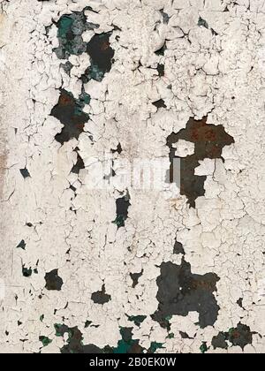Paint peeling off a rusty metal surface - background - texture. Stock Photo