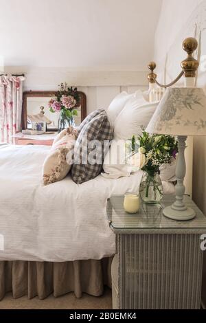 Lloyd Loom bedside table painted in Farrow & Ball’s Hardwick White. Stock Photo