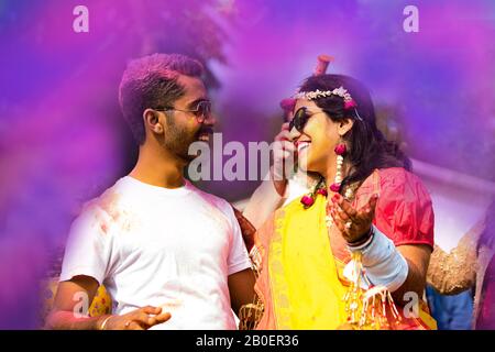 Indian Couple Dancing and Playing With Colors in Indian Festival Holi Stock Photo
