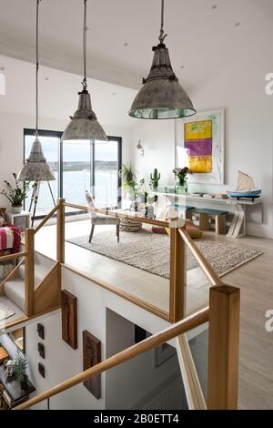 Reclaimed lights in double height split-level renovation with view to Fistral Beach Stock Photo