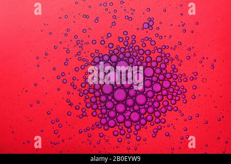 Red and purple water bubbles macro abstract background Stock Photo