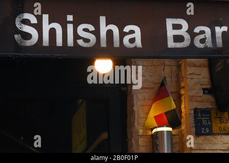 Berlin, Germany. 20th Feb, 2020. A small Germany flag hangs in front of a shisha bar in Berlin-Neukölln. Credit: Sonja Wurtscheid/dpa/Alamy Live News Stock Photo