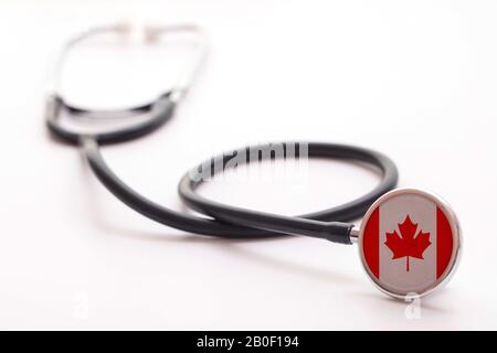 Canada healthcare concept. Medical stethoscope with country flag Stock Photo